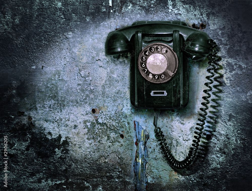 An old black telephone with the number 0 on it
