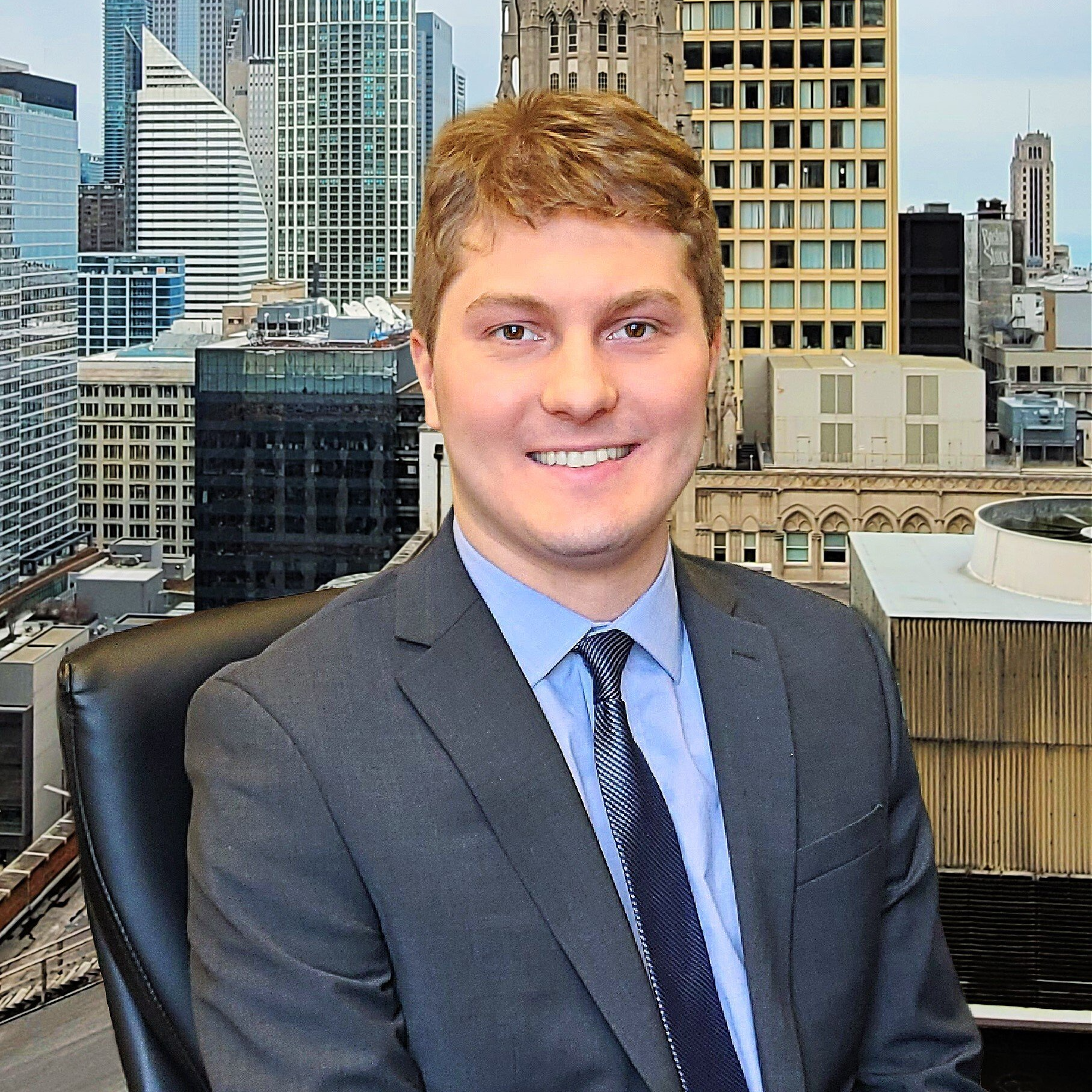A man in a suit and tie is sitting in front of a city skyline