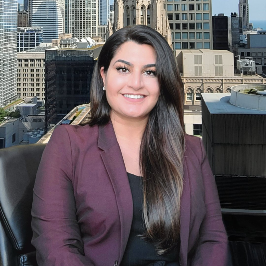 A woman in a purple jacket is sitting in front of a city skyline