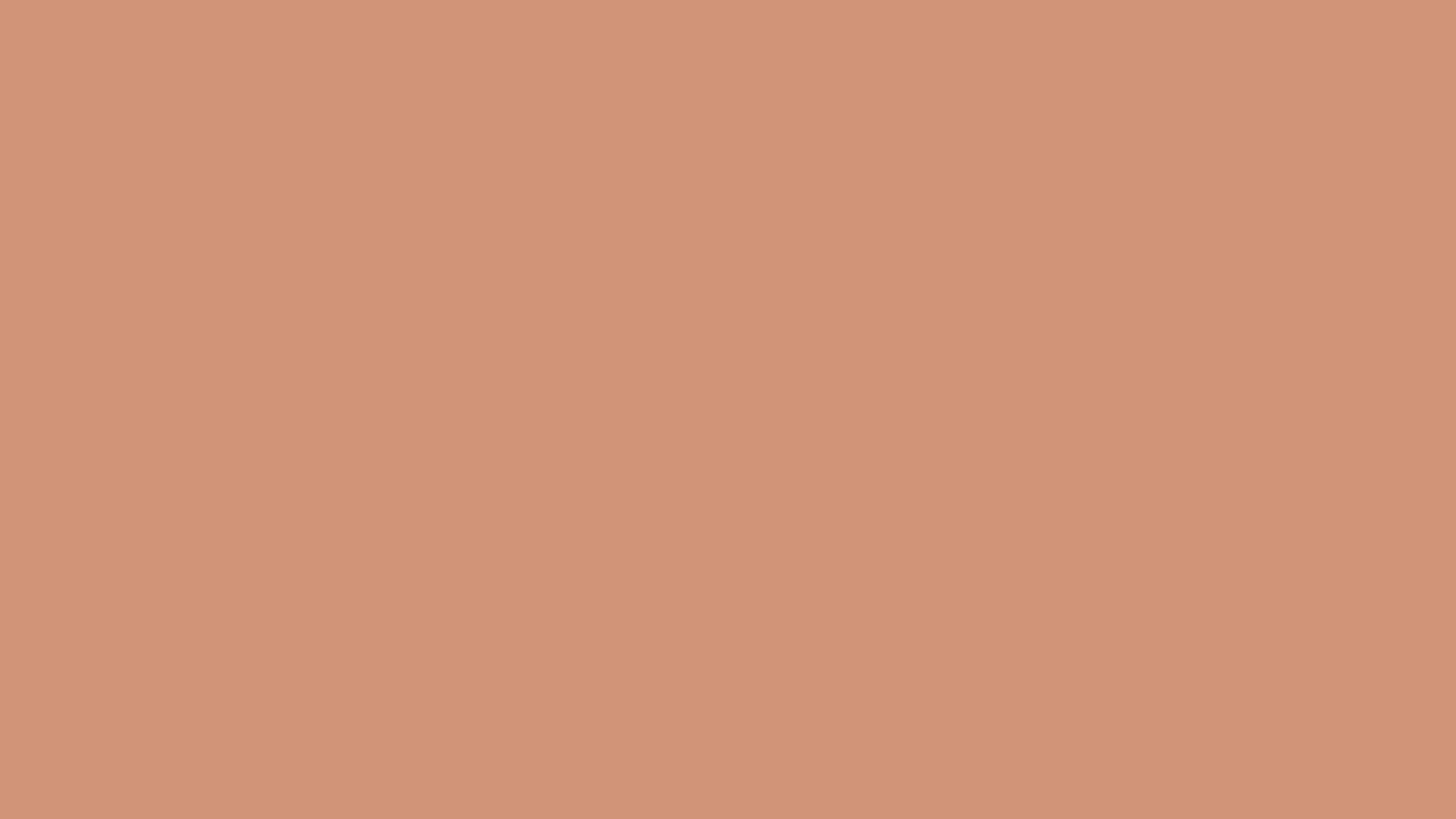 A close up of a plain peach color background.