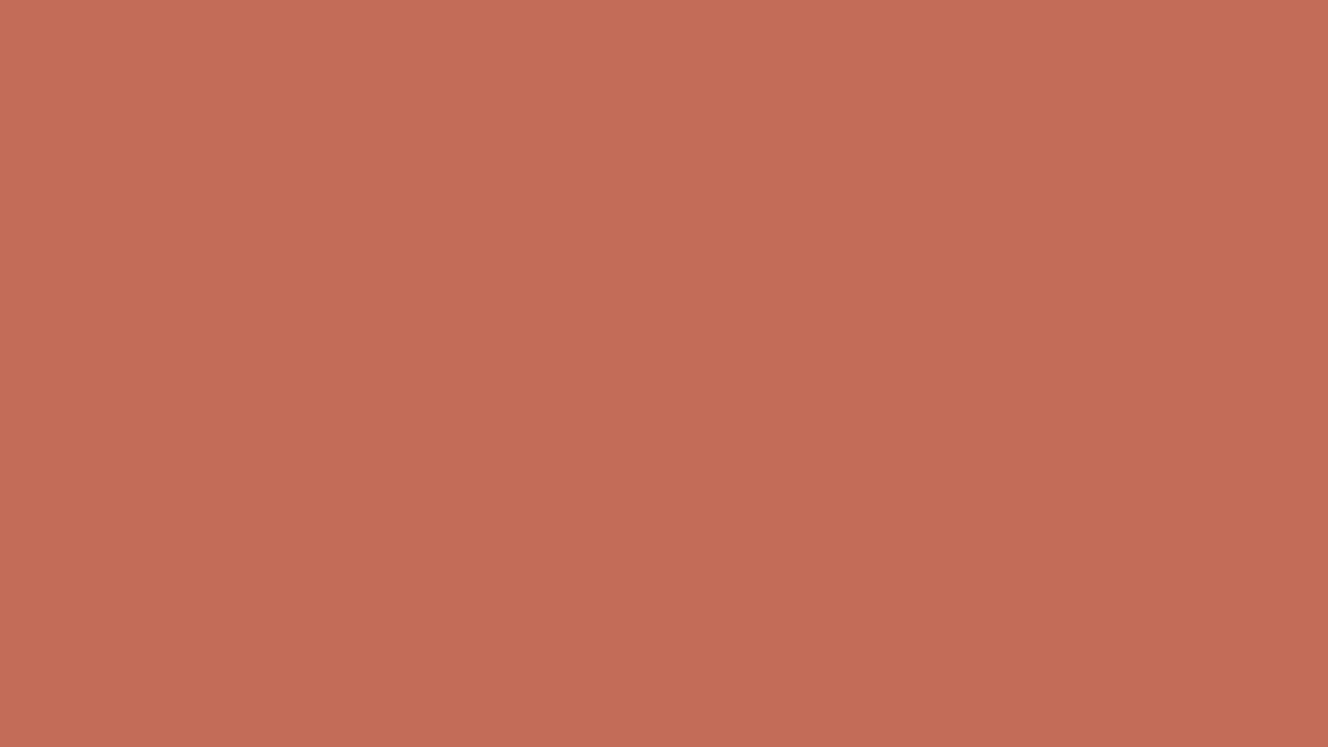A close up of a plain red background.
