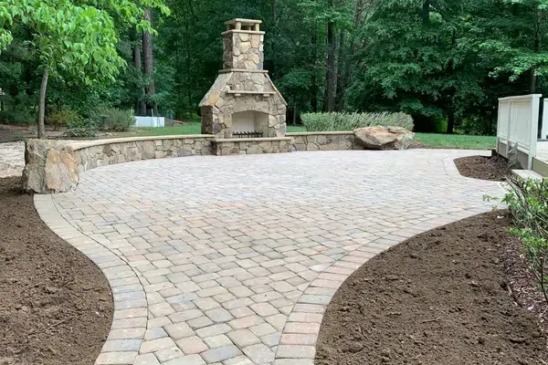 There is a fireplace in the middle of the patio.