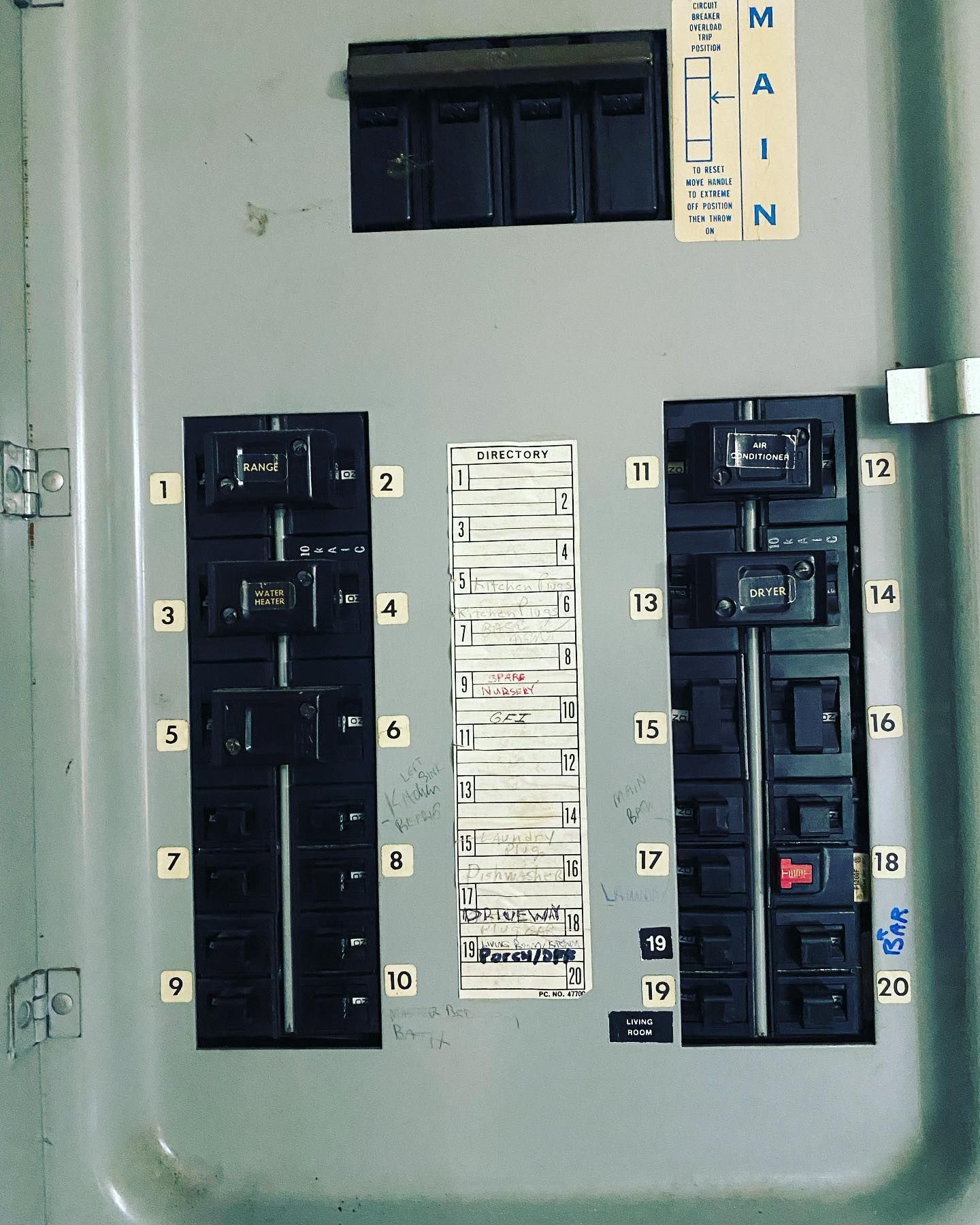 Electrical circuit breaker panel with numbered breakers and labels.
