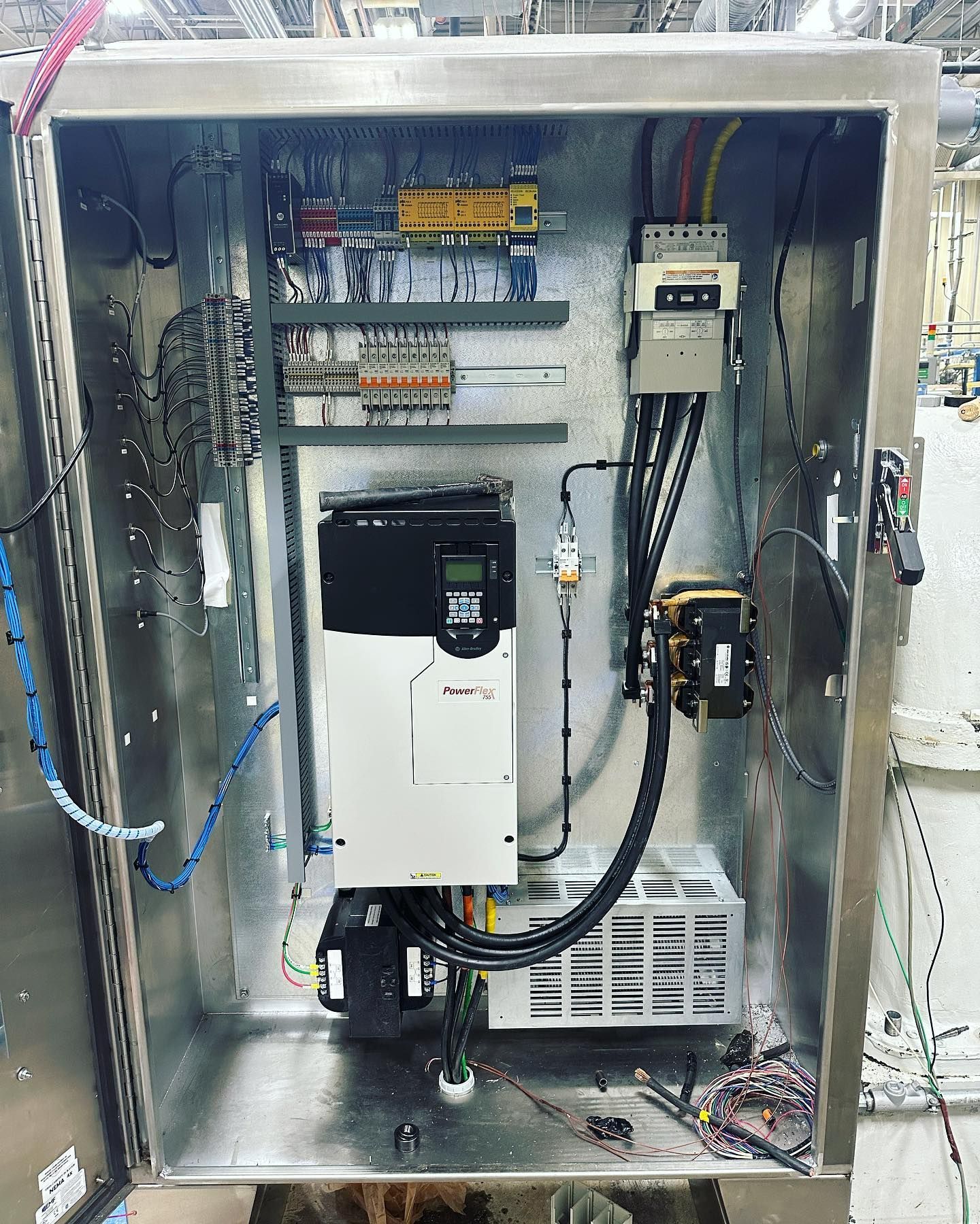 Metal electrical control panel with various components and wiring.