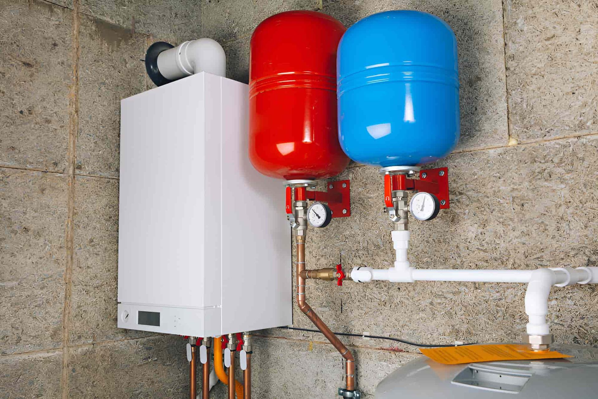 A Boiler With Two Red And Blue Tanks Attached To It — Gillen Plumbing In Ciccone, NT