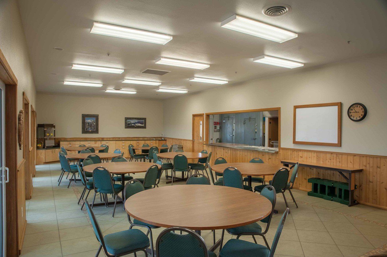 A large room with tables and chairs in it.
