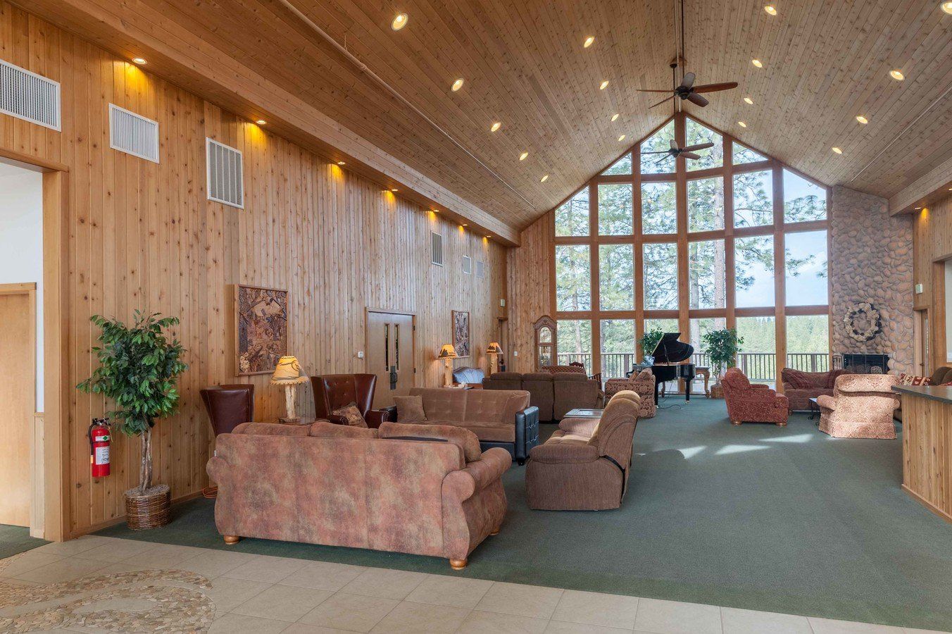 A large living room with lots of furniture and a piano