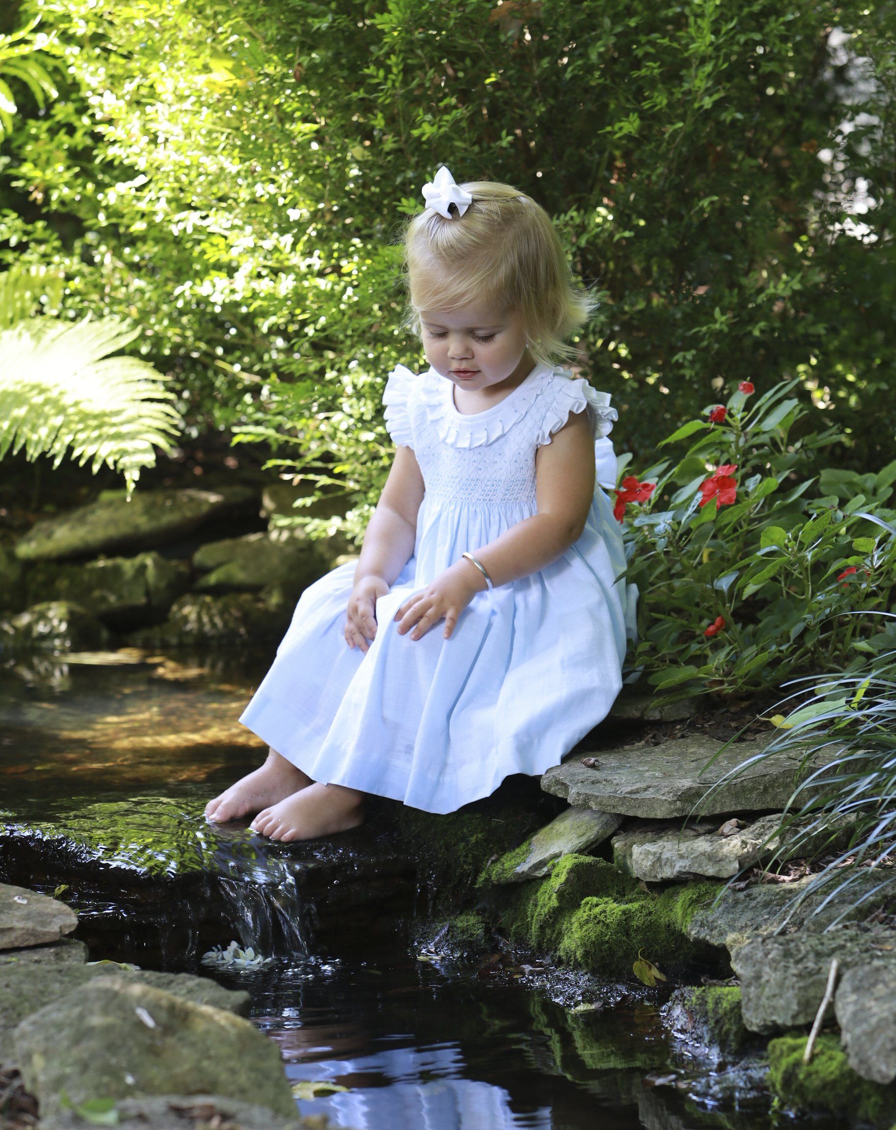 Outdoor picture of girl playing in pond