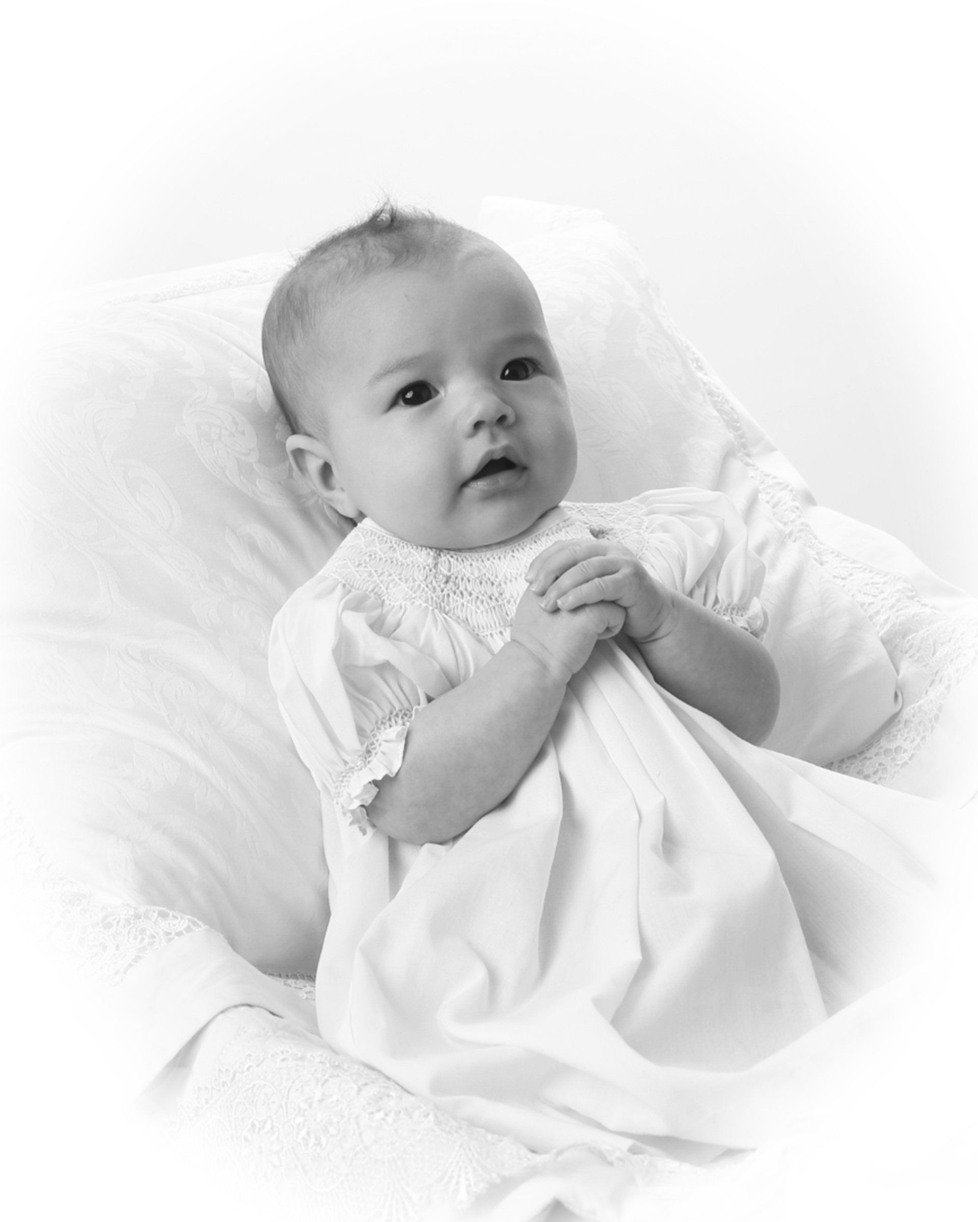 Vintage black and white baby photo with hands clasped