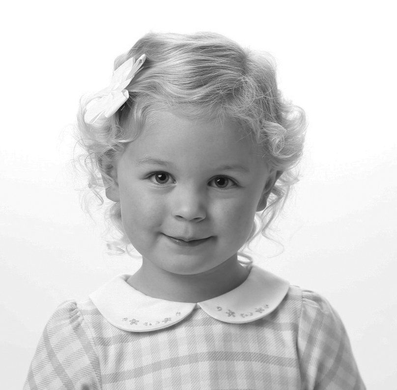 Cute black and white photo of girl with bow