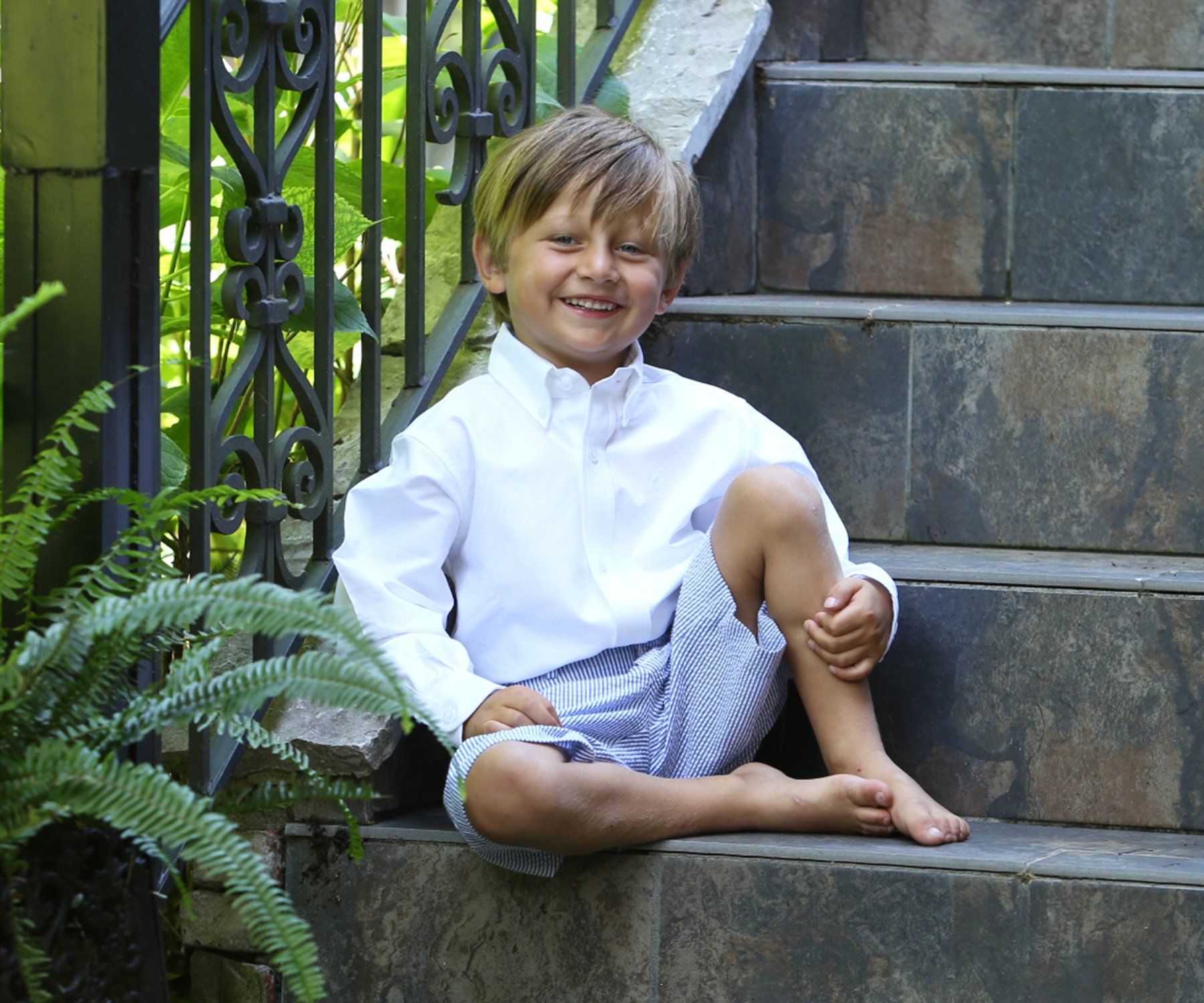 Outdoor portrait of boy on steps