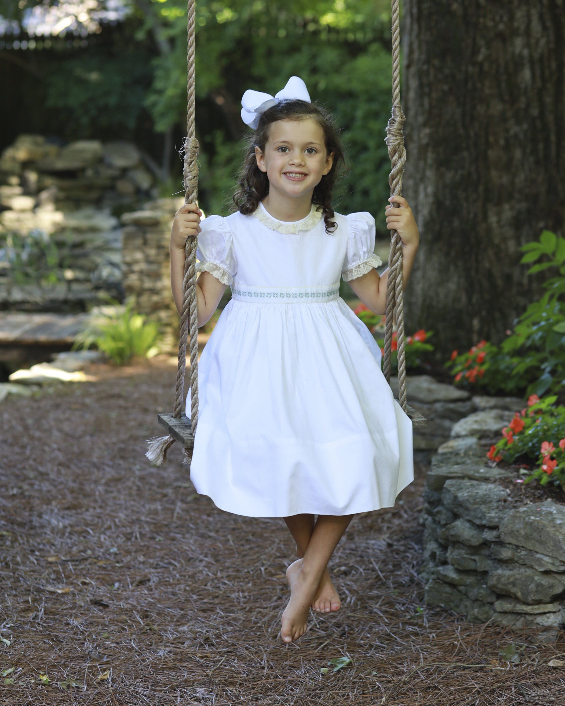 Outdoor portrait of girl swinging in yard