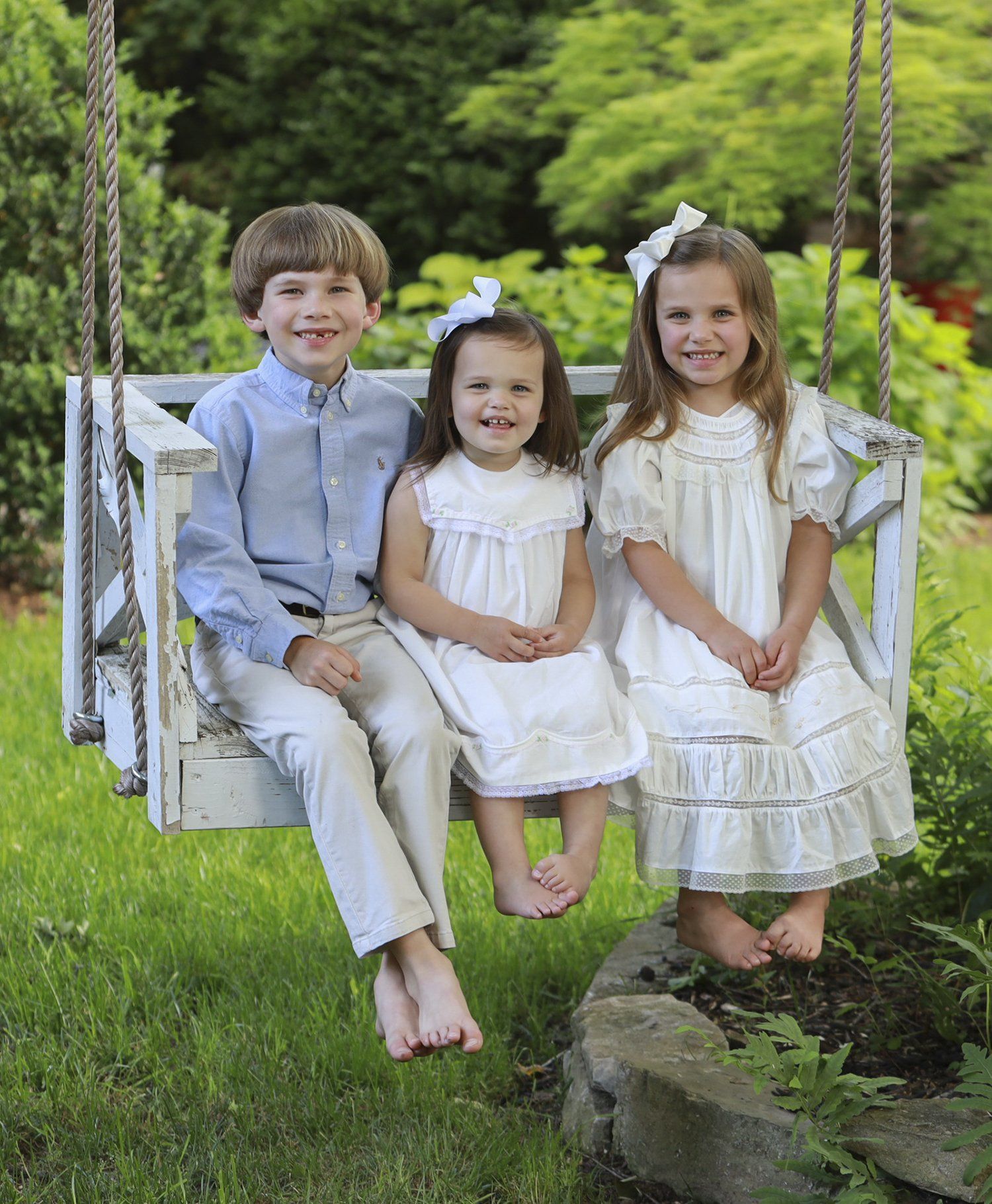 Outdoor portrait of siblings on swing