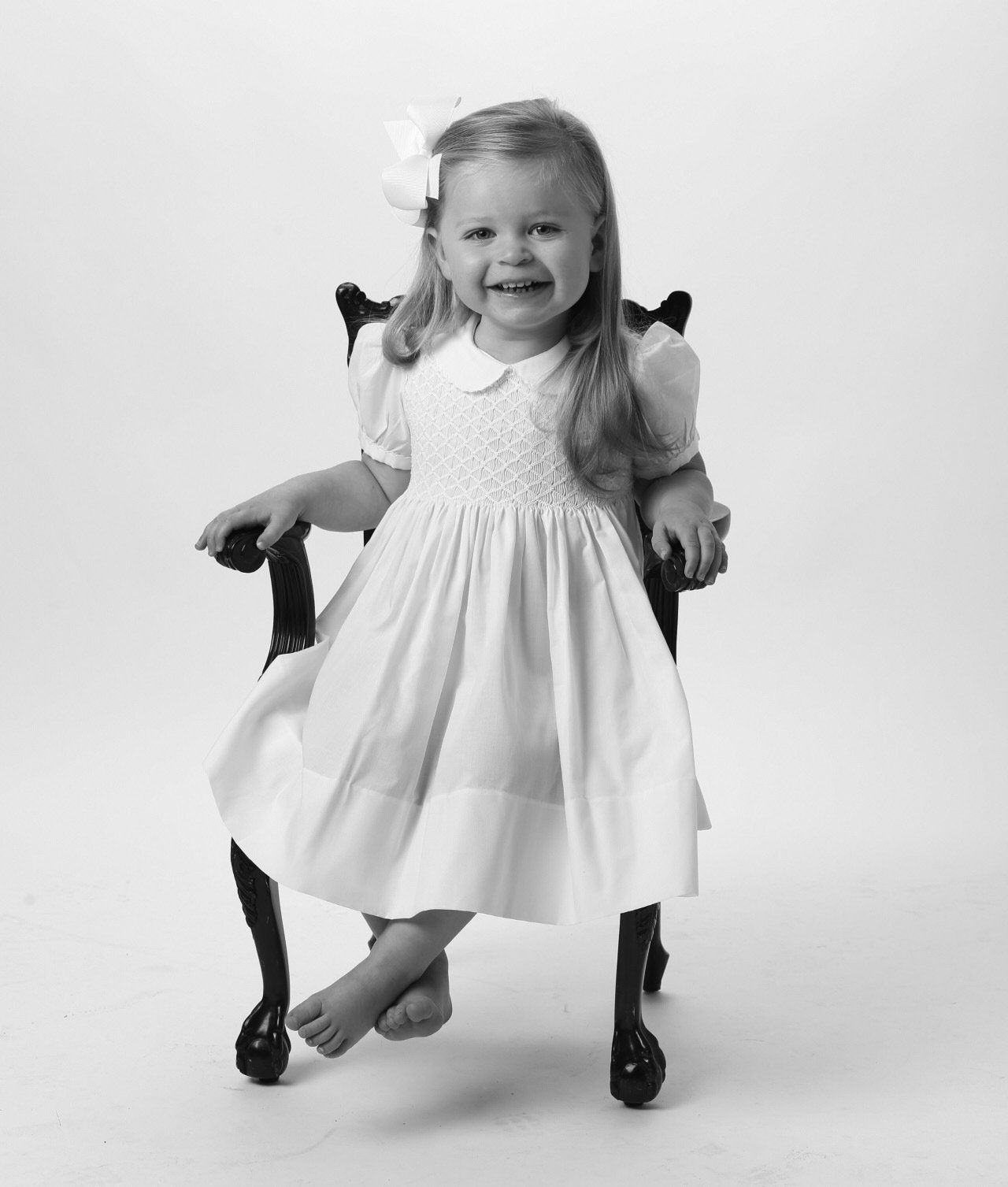 Black and white photo of girl in rocking chair