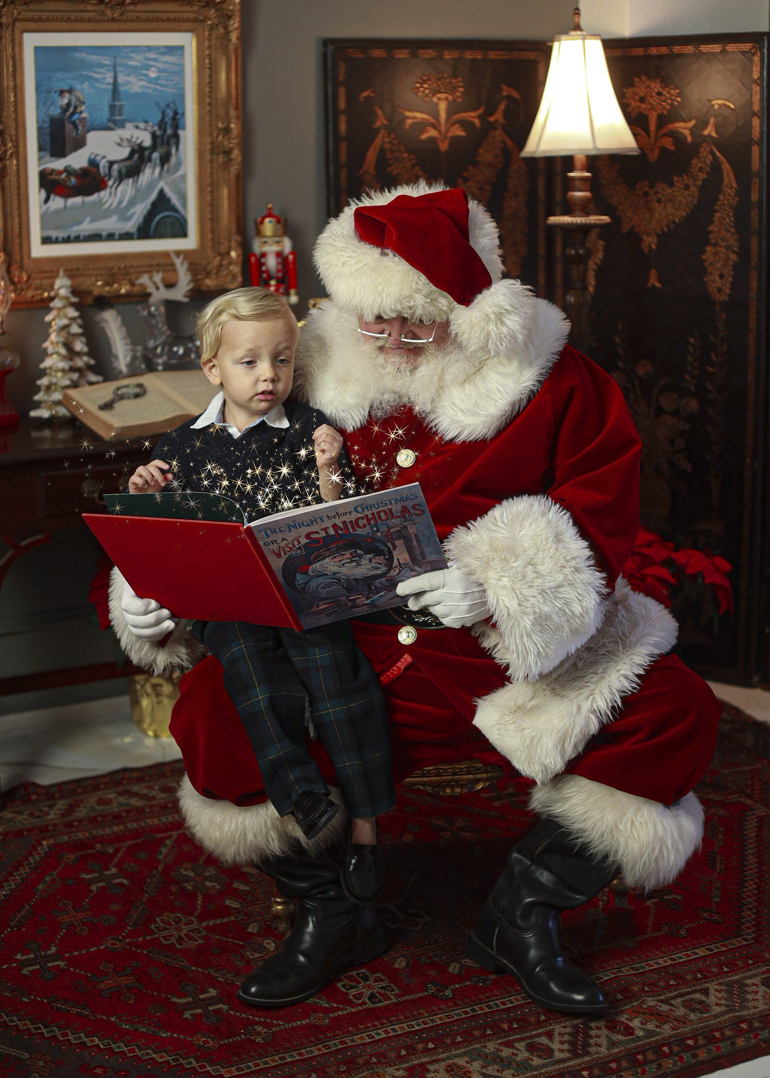 Santa reading a book to boy