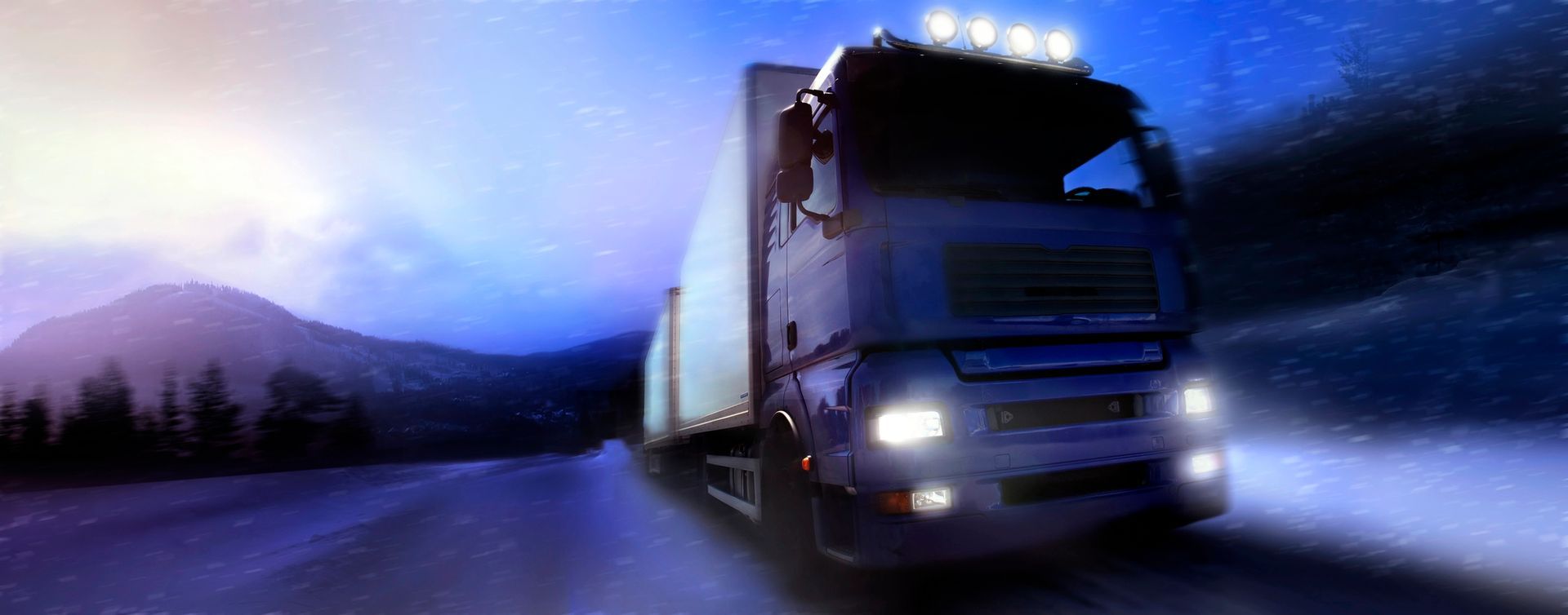 A semi truck is driving down a snowy road at night.