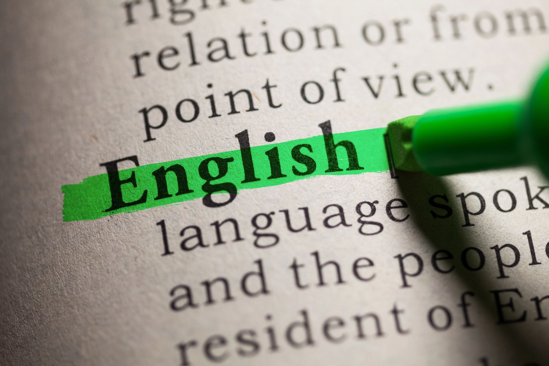 The word English is highlighted in green in a dictionary