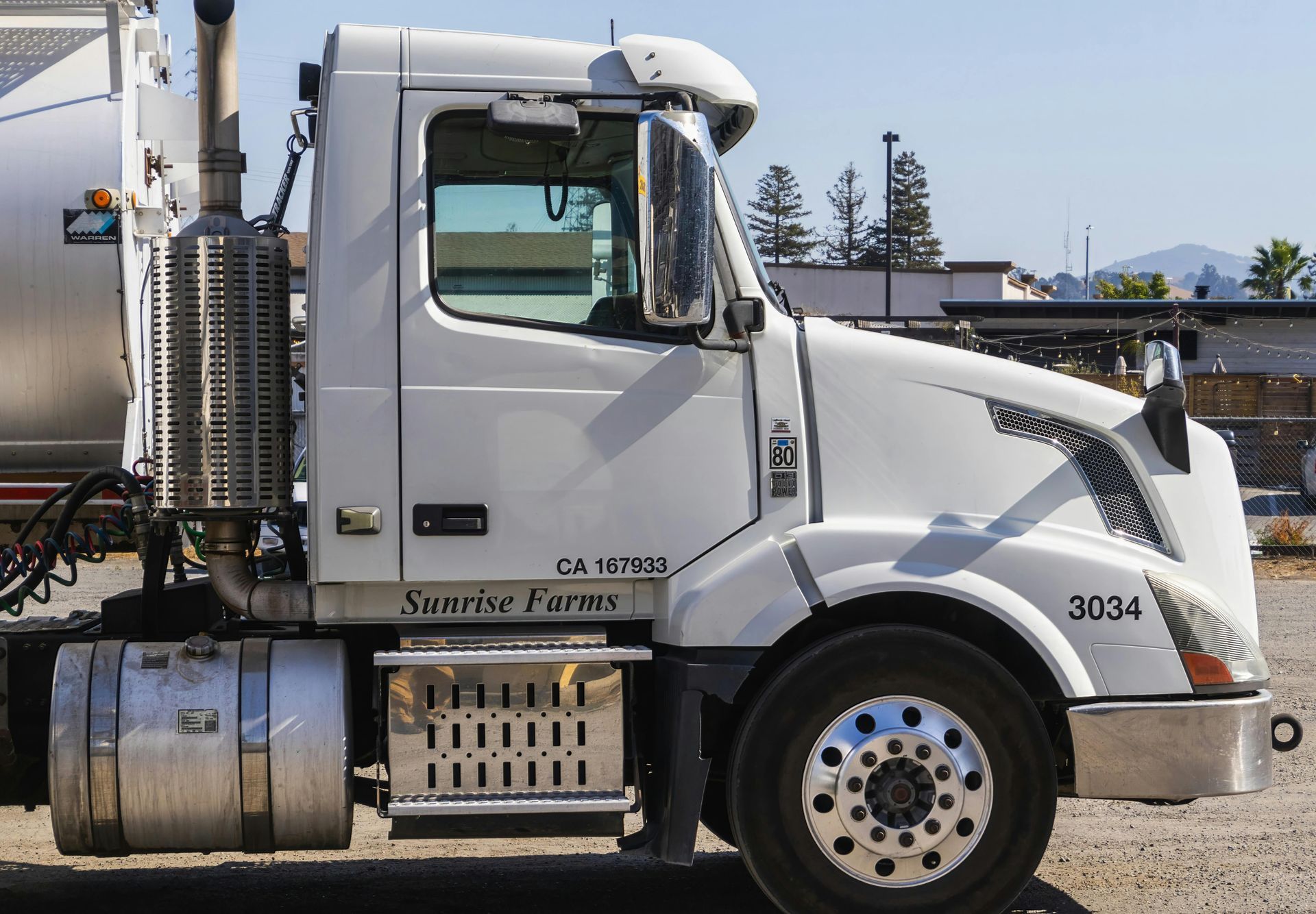 A white semi truck with the number 3034 on the side