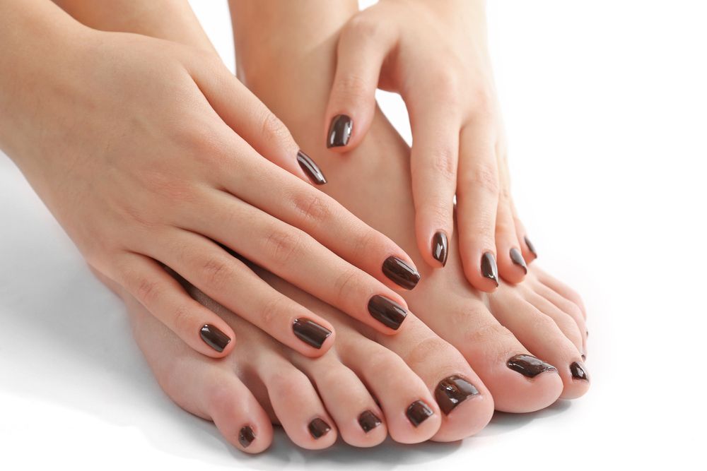 Hands and Feet With Dark Brown Nail Polish — Aspire Beauty & Nails in Wagga Wagga, NSW