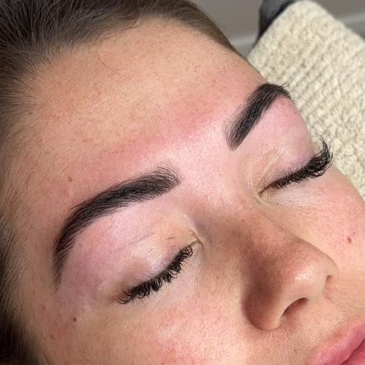 Woman with Closed Eyes Newly-Shaped Dark Eyebrows — Aspire Beauty & Nails in Wagga Wagga, NSW