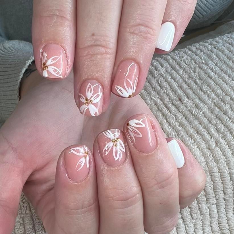 Hands With Light Pink Nails Decorated With White Floral Designs — Aspire Beauty & Nails in Wagga Wagga, NSW