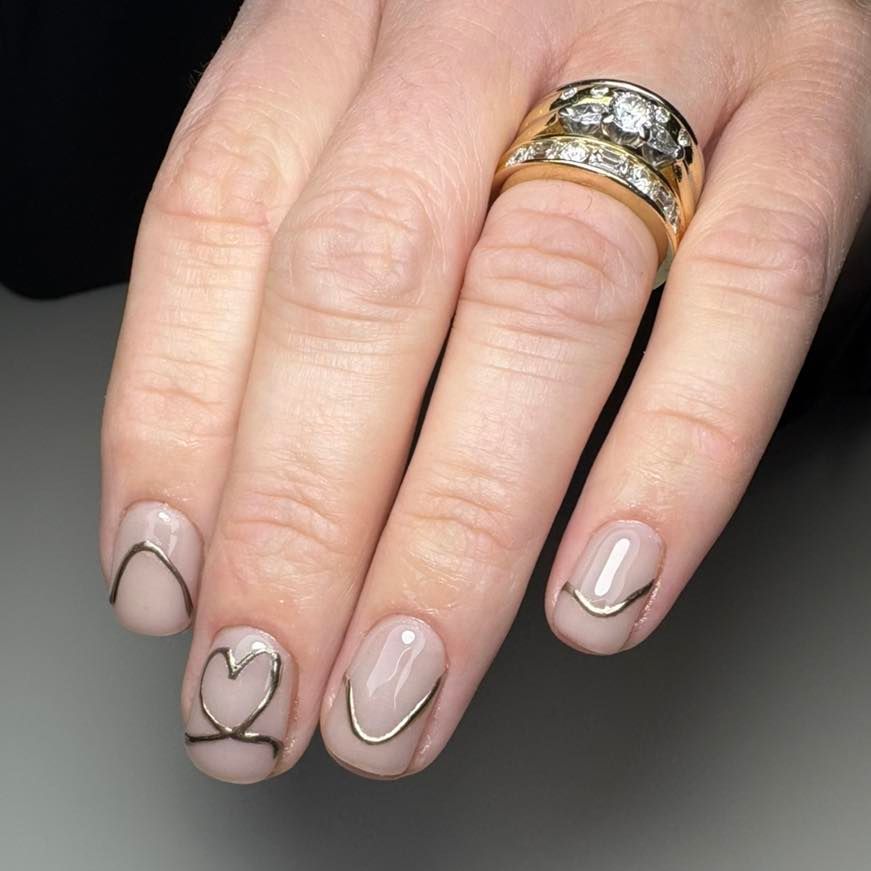 Hand With Gold Ring and Neutral Nail Polish Featuring Gold Outlines — Aspire Beauty & Nails in Wagga Wagga, NSW