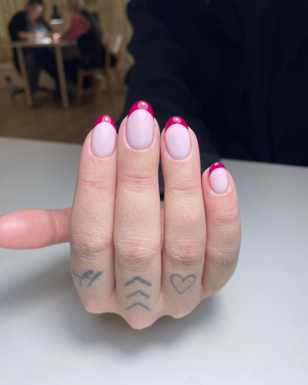 Hand With Pink Nails, Red French Tips, and Finger Tattoos — Aspire Beauty & Nails in Wagga Wagga, NSW