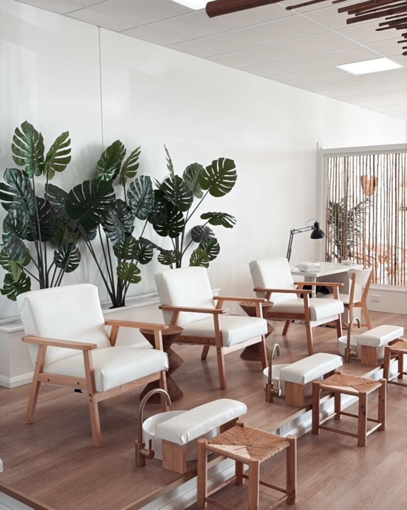 Wooden applicator dripping wax into a wax warmer — Aspire Beauty & Nails in Wagga Wagga, NSW