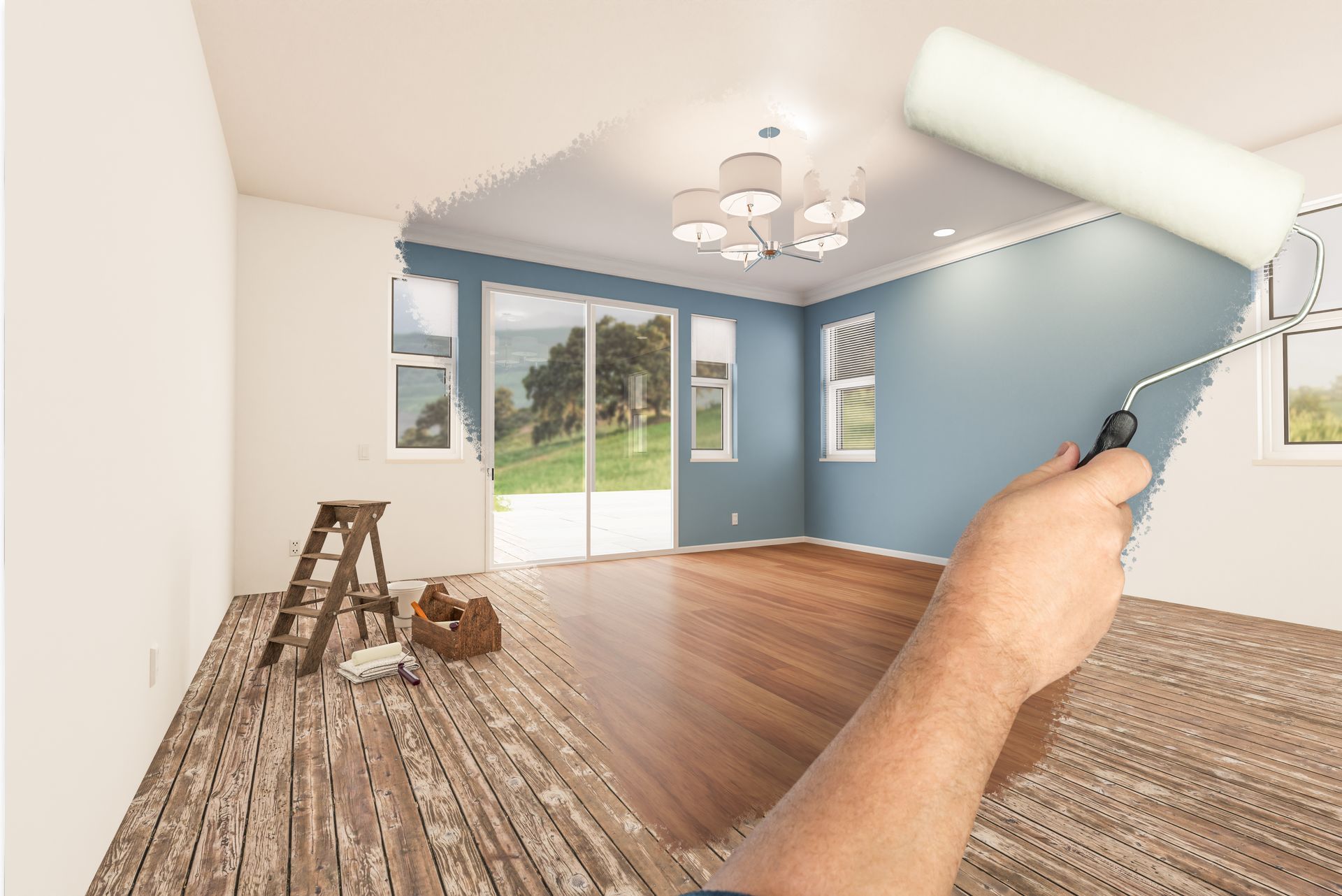 Hand painting a blue room with a roller; ladder, tools, and wood floor visible, with sliding glass doors.