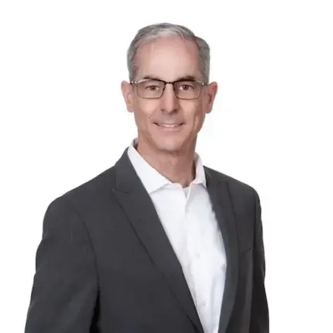 A man wearing glasses and a beanie is taking a selfie.