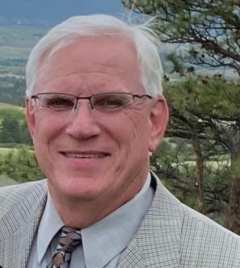 A man wearing glasses and a beanie is taking a selfie.
