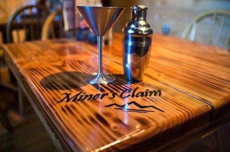 A wooden table with miner 's claim written on it