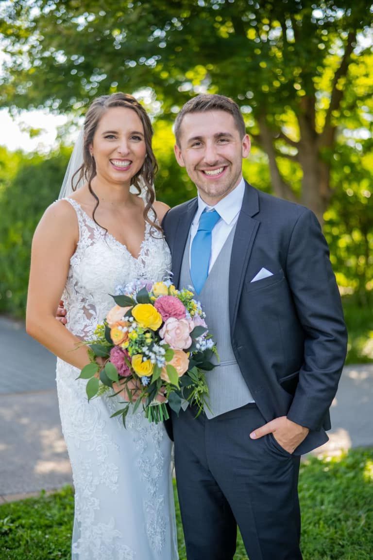 bride and groom with wooden wedding flowers