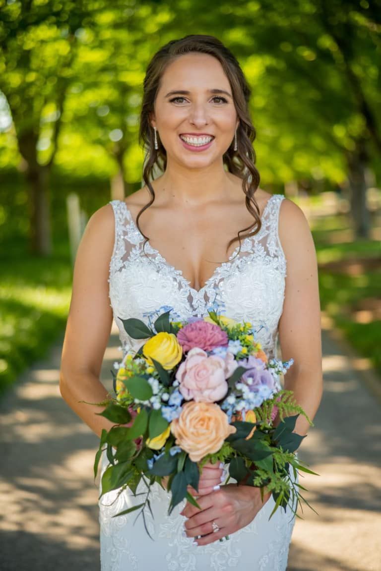 bride holding wooden bridal bouquet