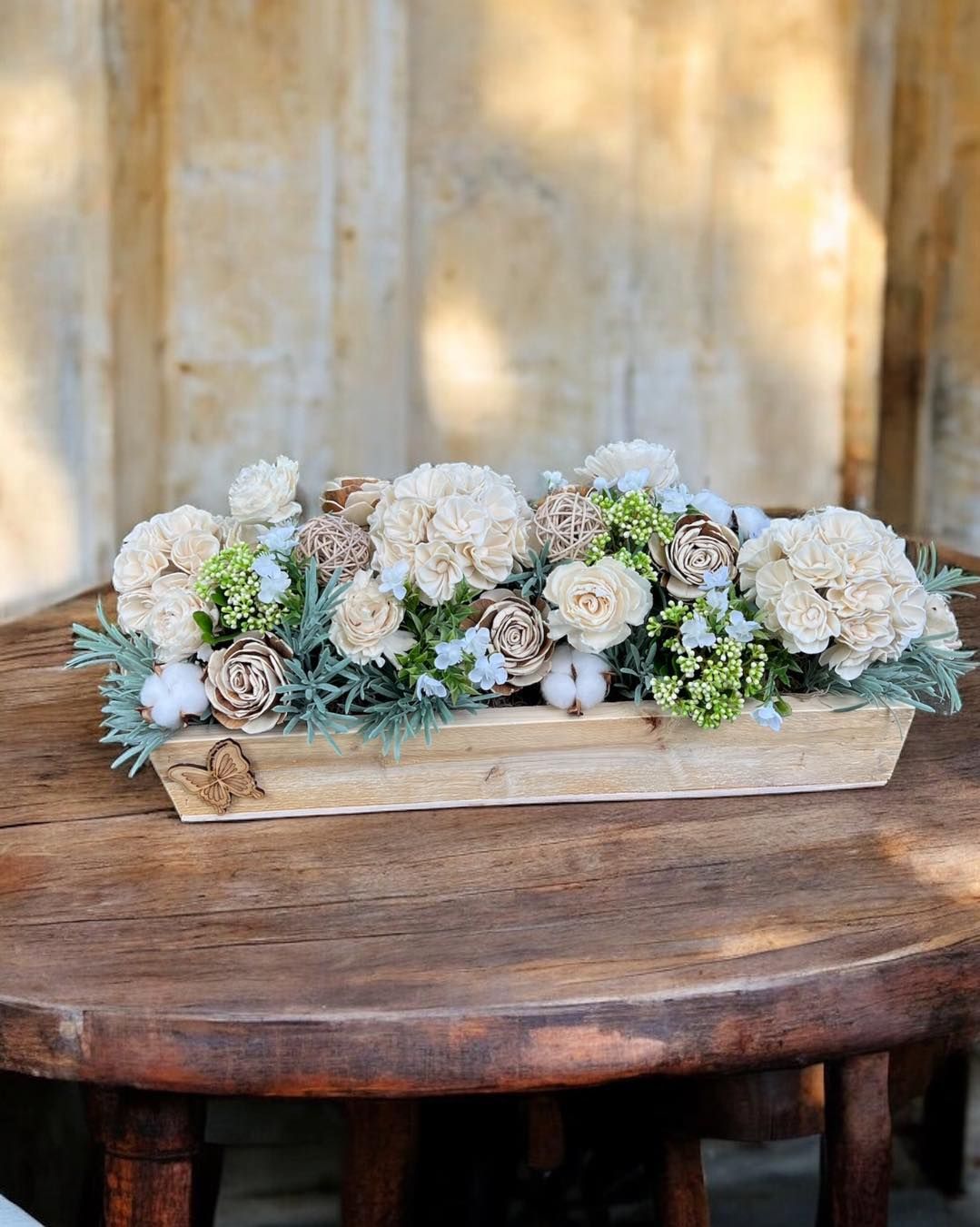 neutral colored wooden flower arrangement