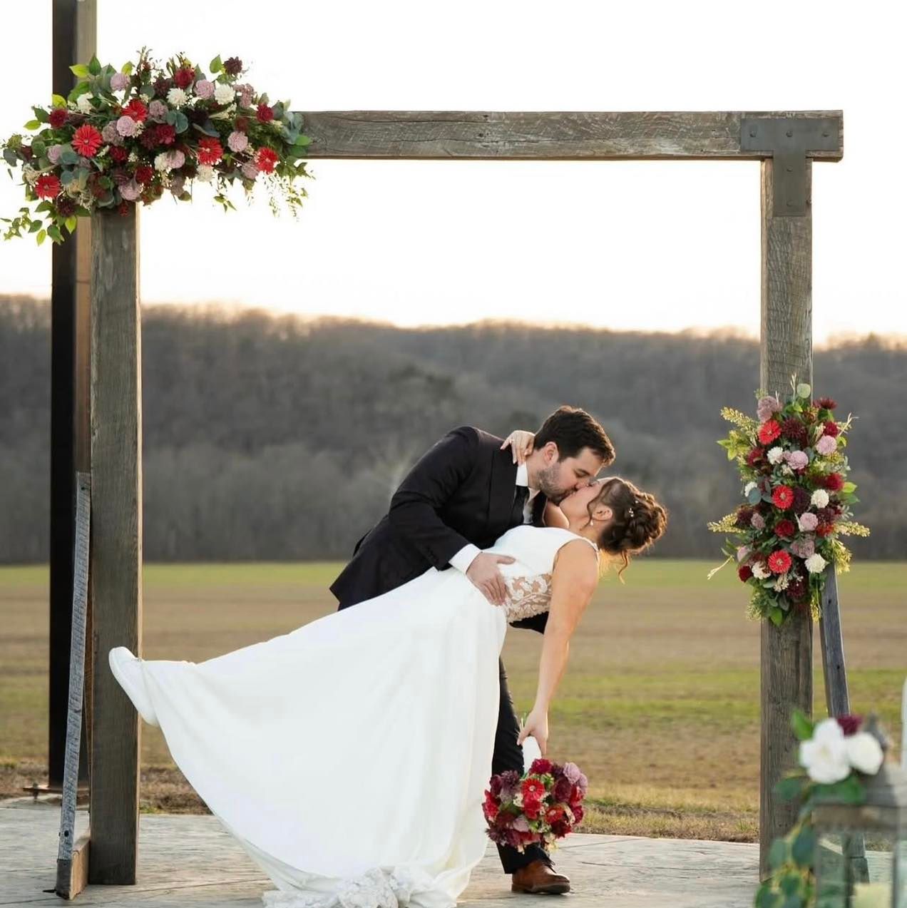 white and red wooden altar flowers for wedding
