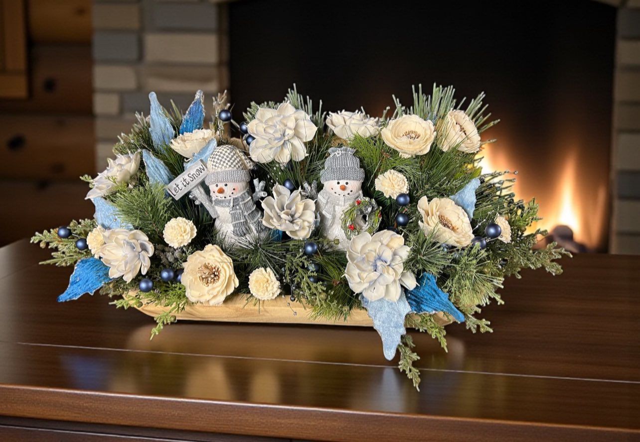 blue and white wooden floral centerpiece with snowmen figurines 