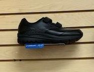 A shoe store with a lot of shoes on display in front of a window.