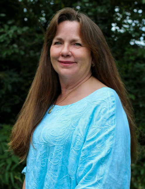 Therese Keeling's headshot in from of a replica of van Gogh's The Starry Night.