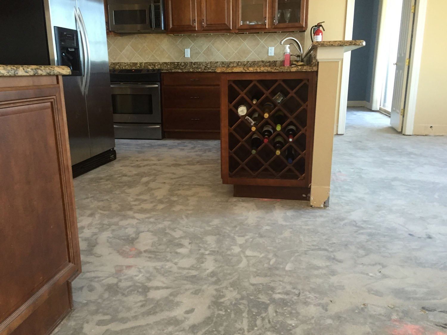A kitchen with a wine rack in the middle of it