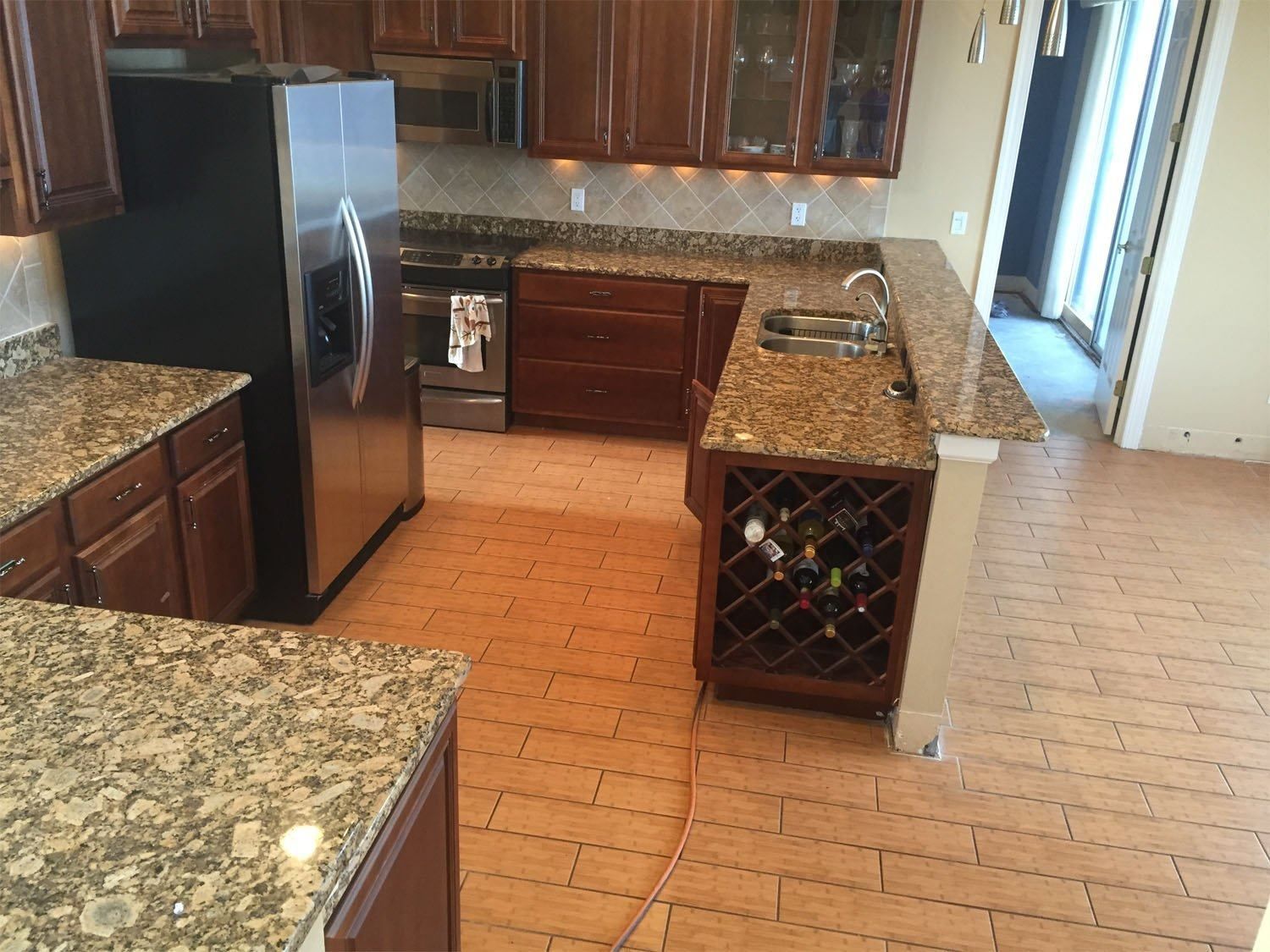 A kitchen with granite counter tops and stainless steel appliances