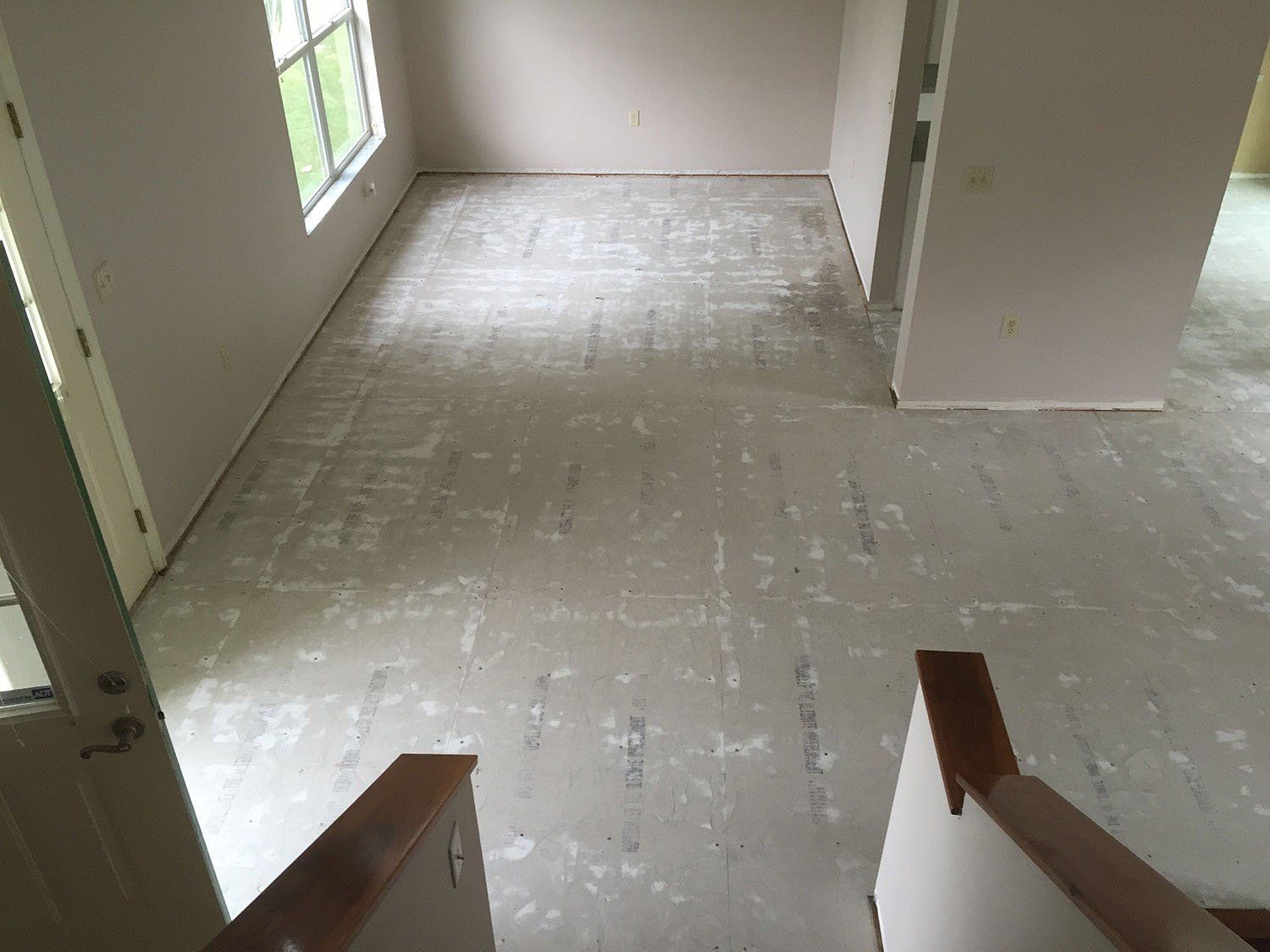 An empty room with a staircase and a window.
