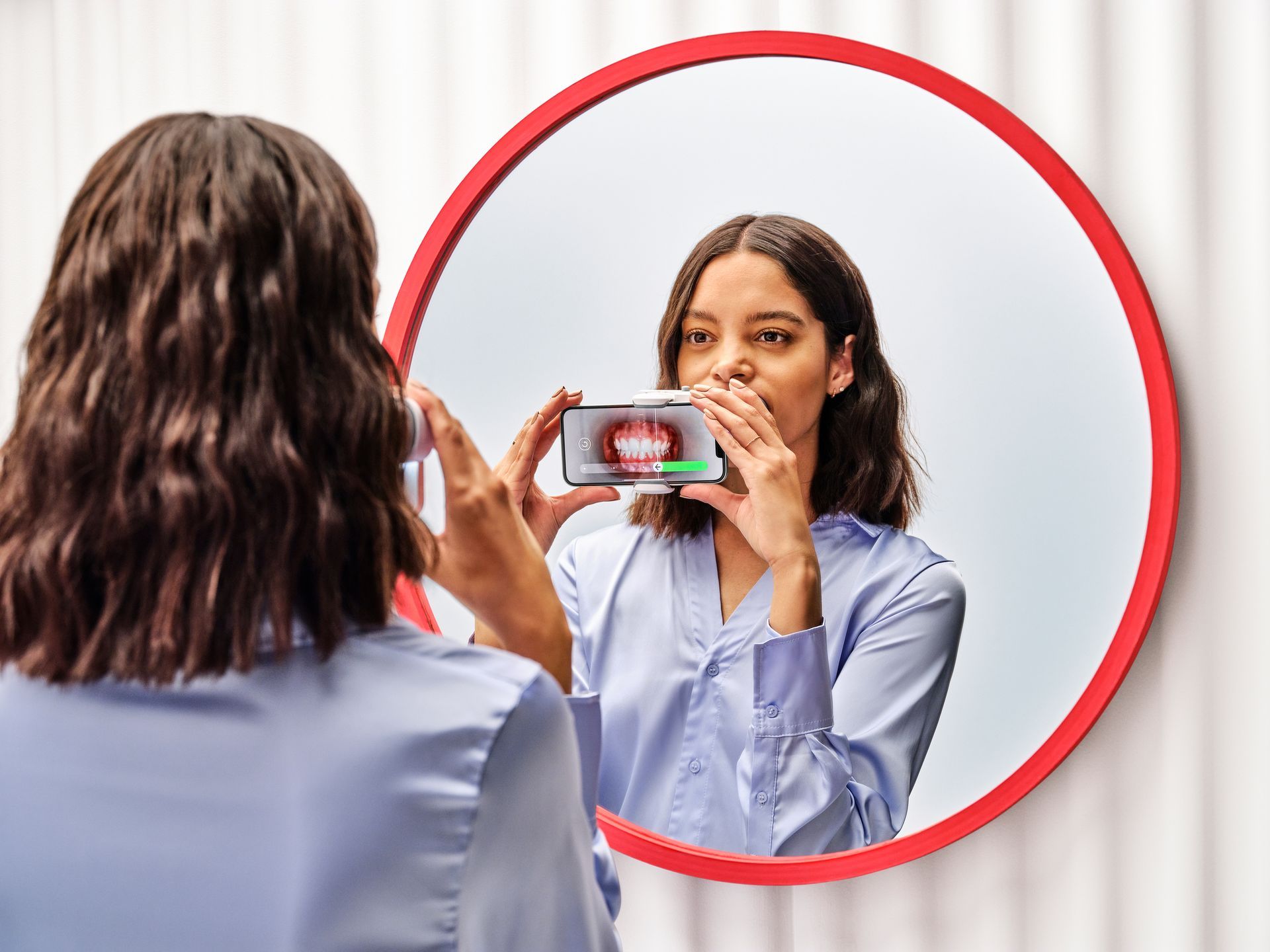 A woman is taking a picture of herself in a mirror.