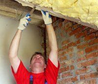 Man Wearing Red Shirt Fixing the Insulation — Travelers Rest, SC — Guy M Beaty Co