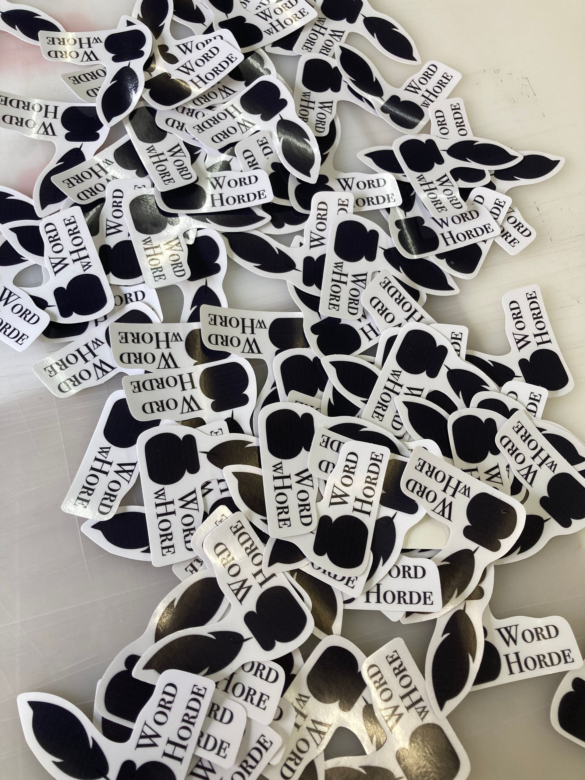 Pile of black and white stickers with the words 