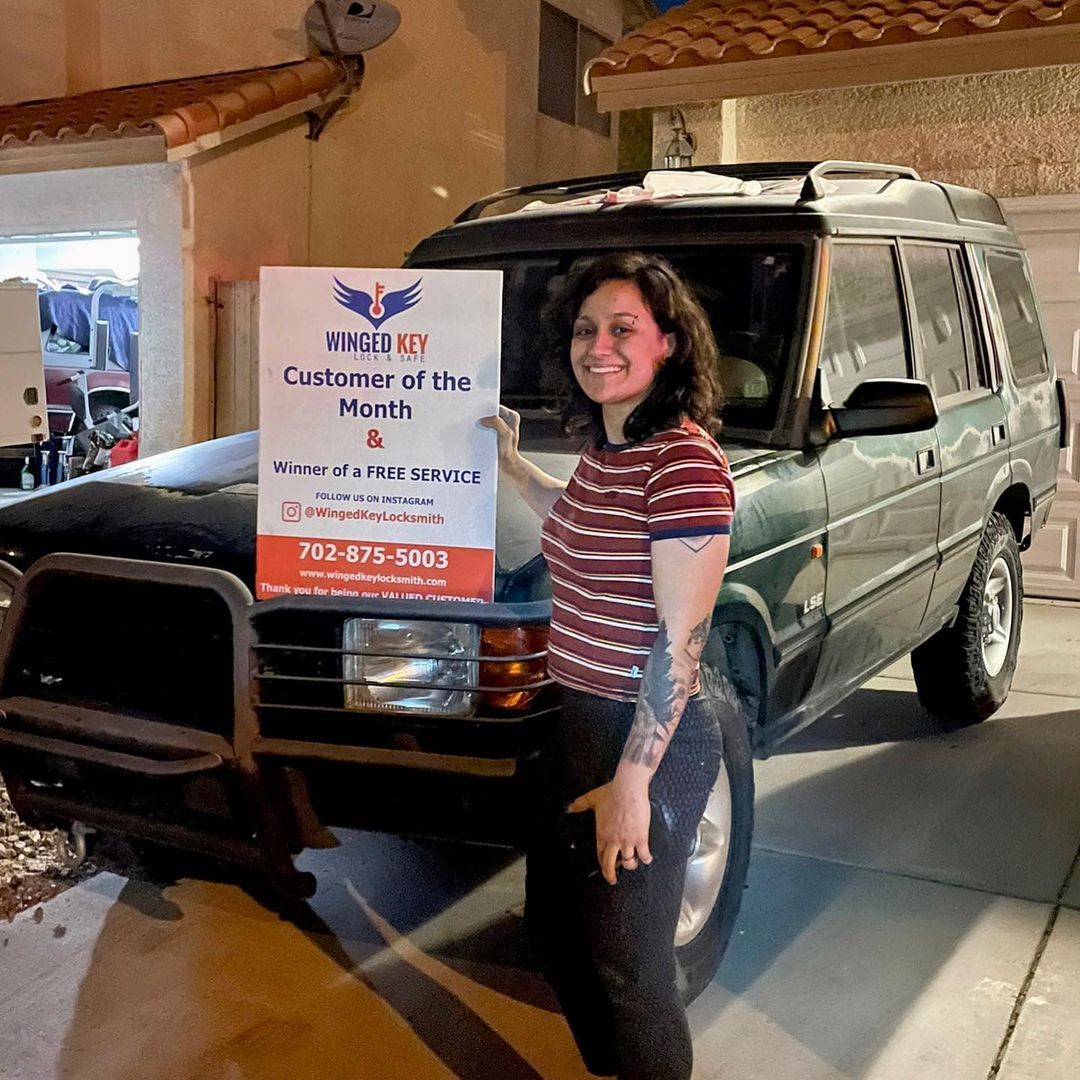 Woman Holding Banner — Las Vegas, Nevada — Winged Key Lock Smith