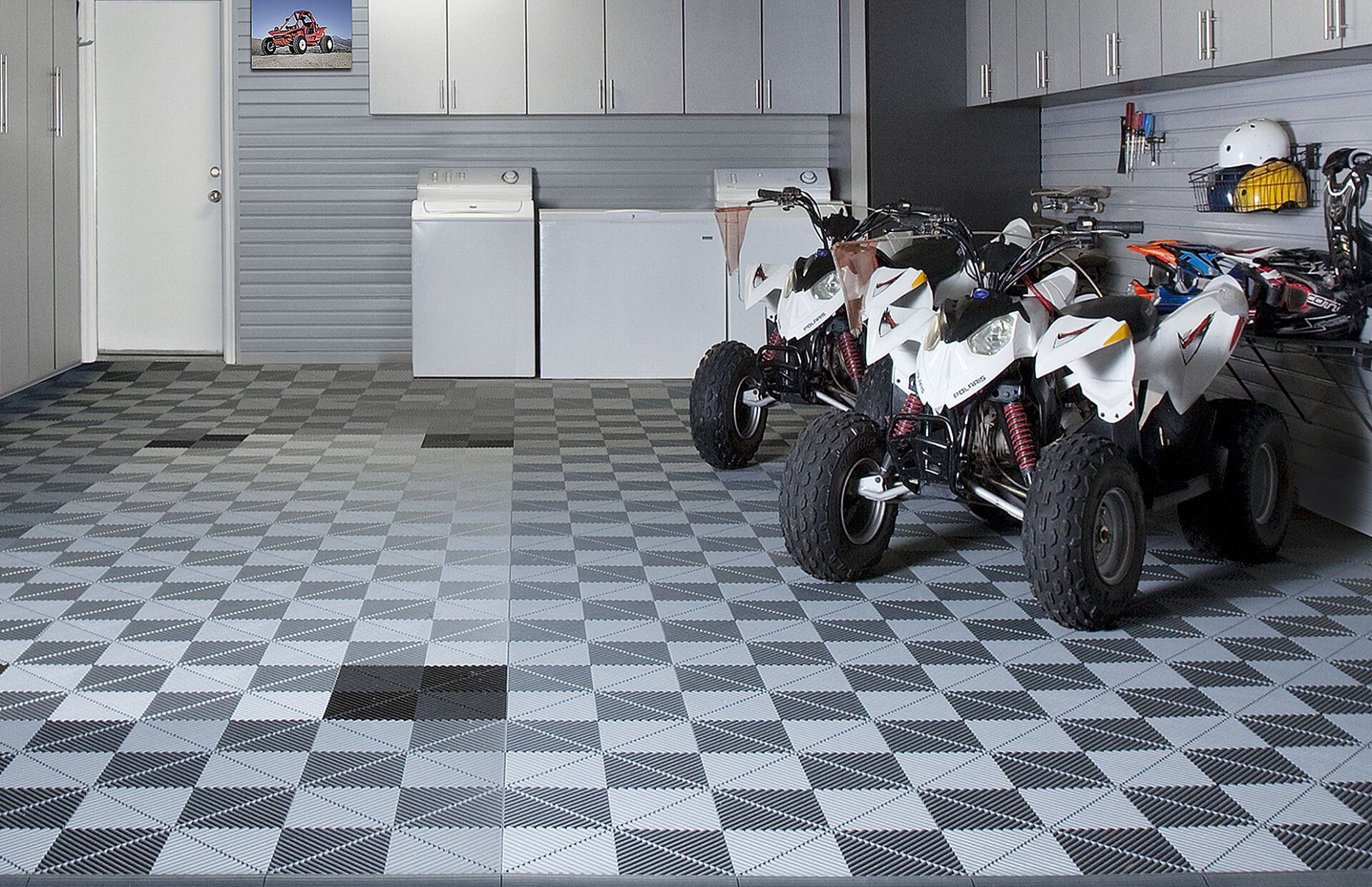 a garage with two ATVs on a Swisstrax floor