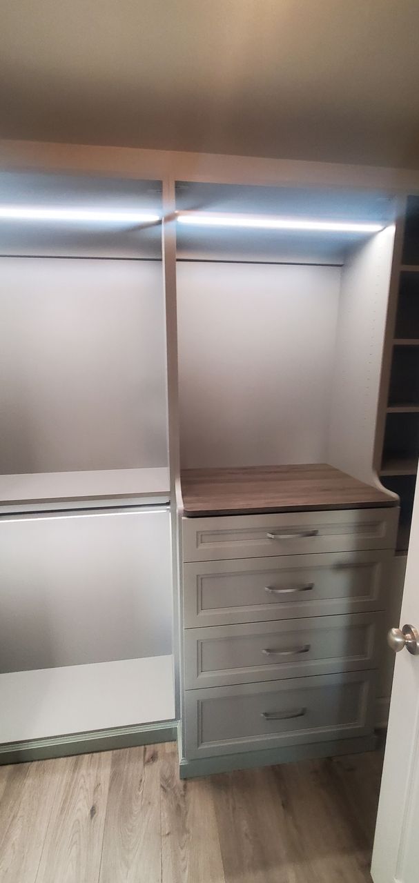a walk-in closet with strip light custom closets with drawers