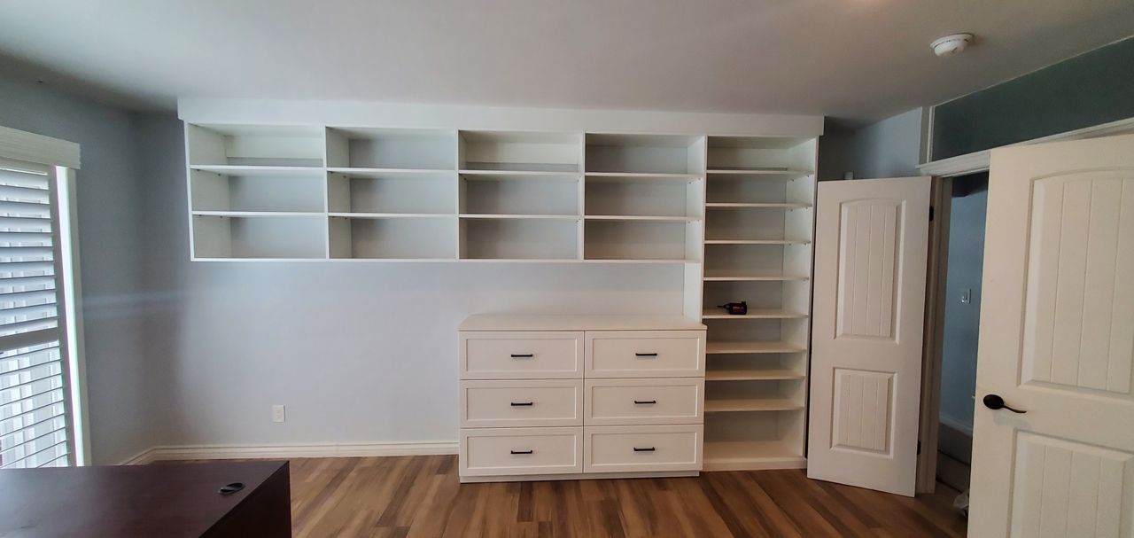 a custom armoire closet with shelves  and drawers