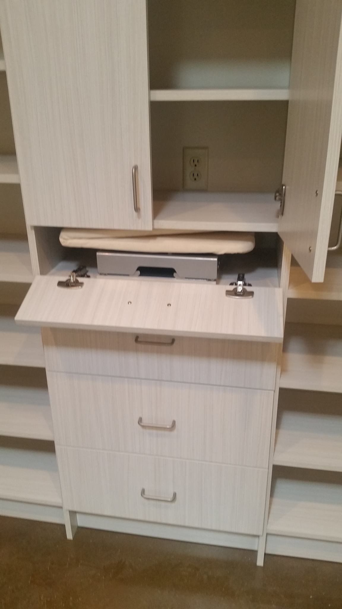 a custom cabinet with tilt down shelf